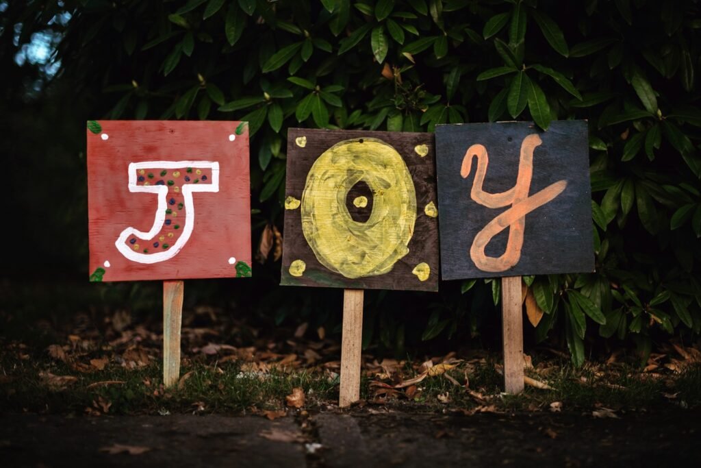 three assorted-color joy signage